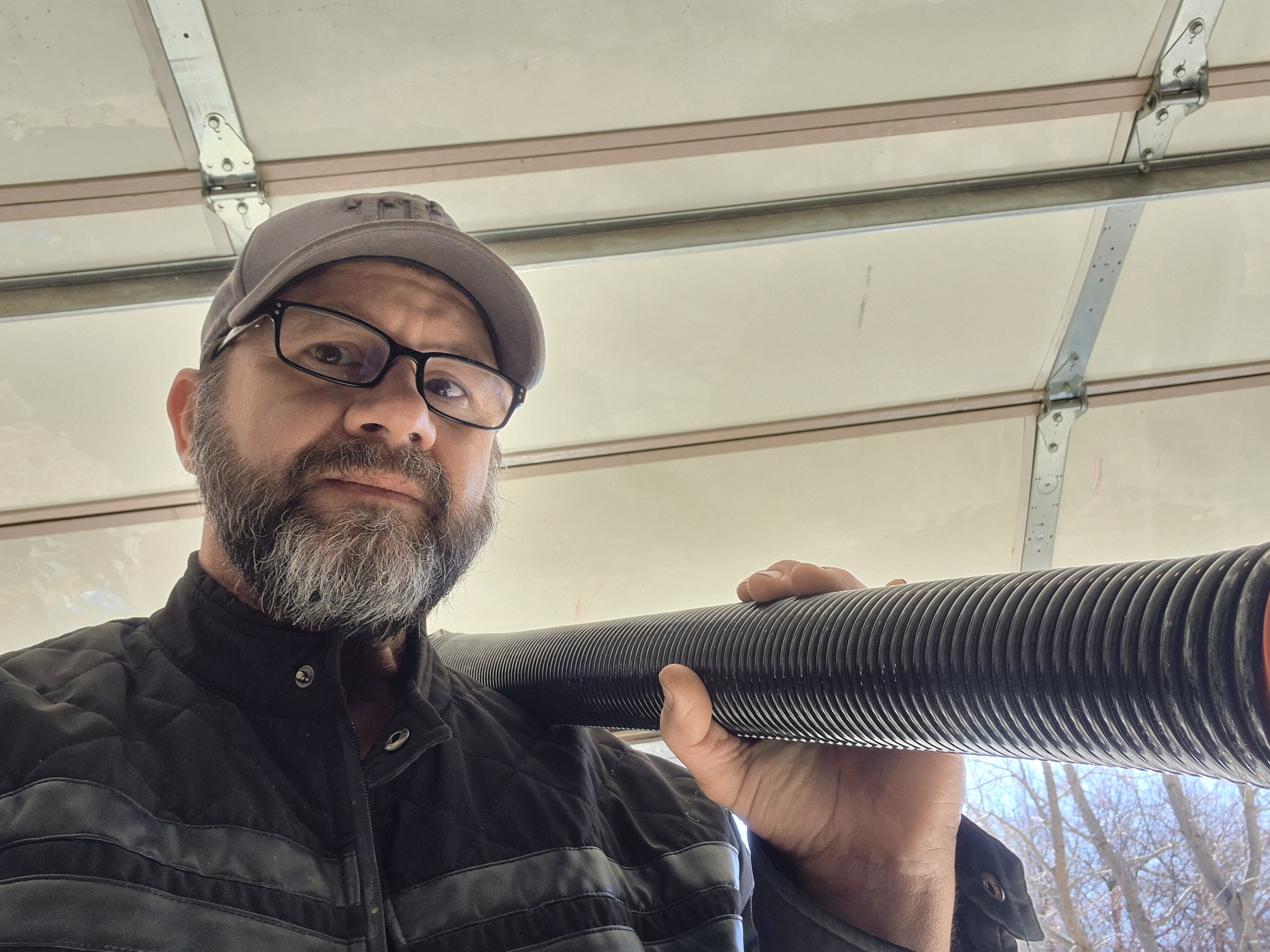 Technician checking spring for garage door that will not open in Sand Springs, OK